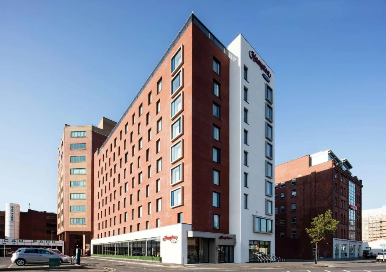 Tall red and white hotel building in Belfast city centre