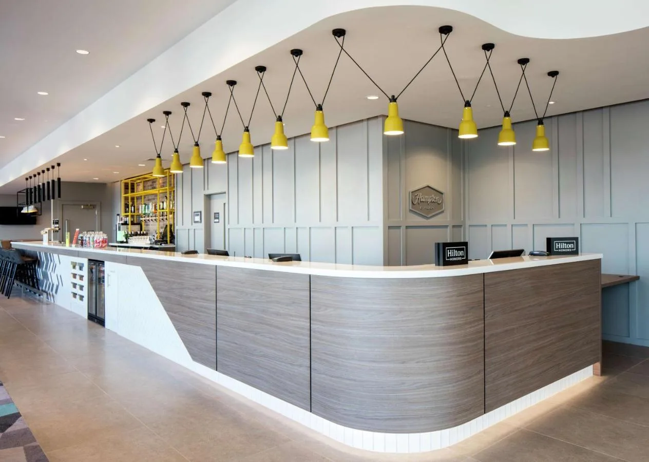 Hotel lobby counter with yellow pendant lighting